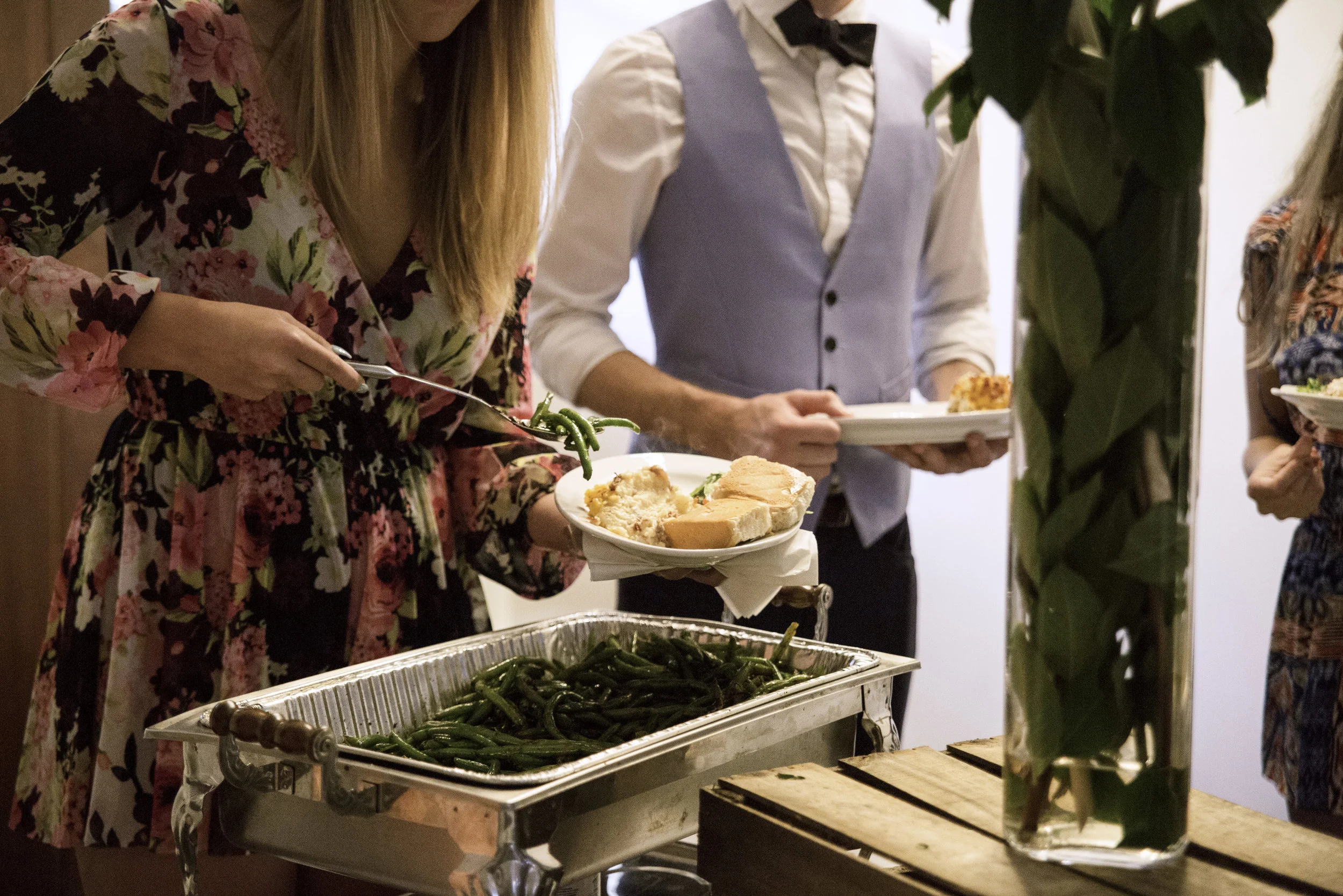 Sass! catering team setting up a buffet station with Southern dishes for a private event
