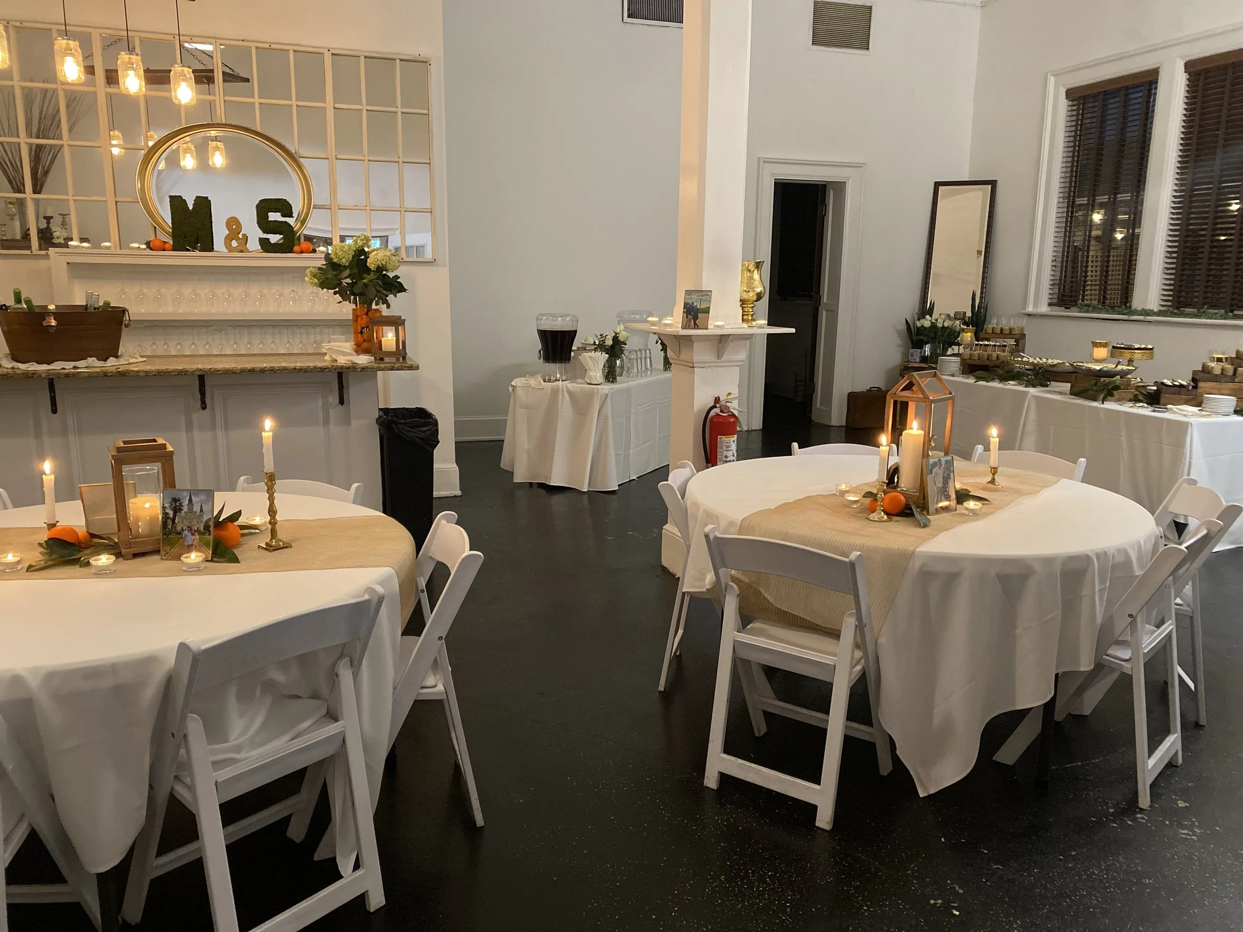 The intimate Dupuy Room with candlelit tables and burlap runners set for a private gathering