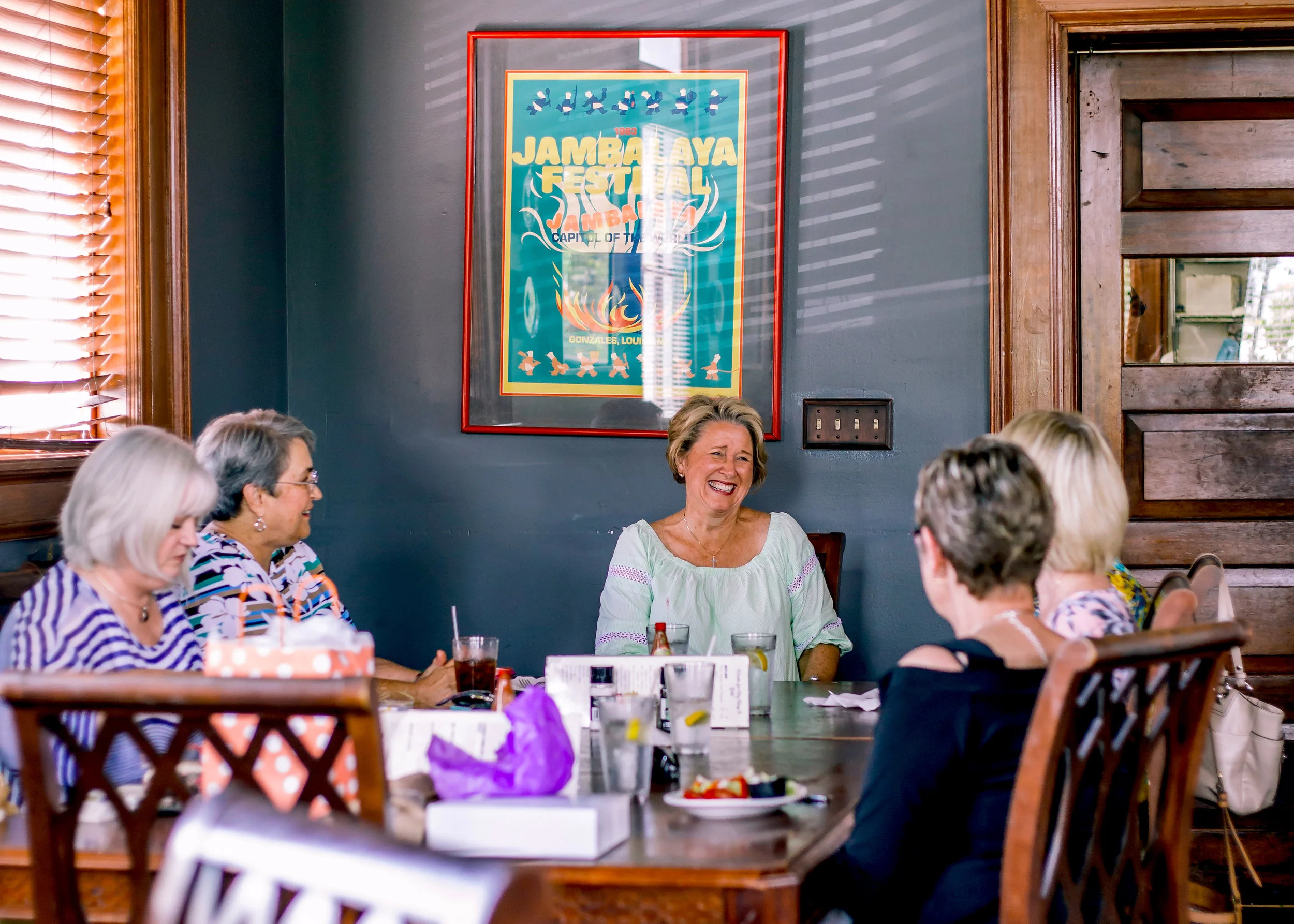 Guests laughing together over a meal at Sass! Restaurant in Thomasville Georgia